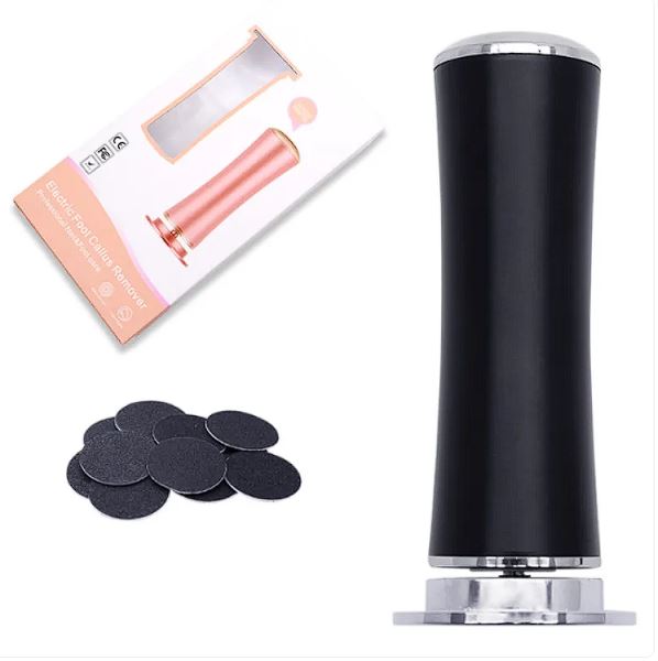Black electric foot file standing upright next to a stack of replacement grinding discs, on a white background