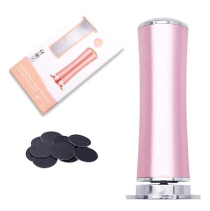 Rose gold electric foot file with replacement grinding discs laid out beside it