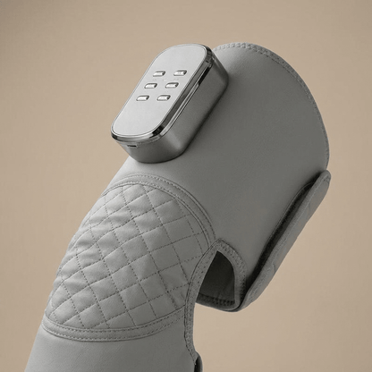 Grey leg massager sleeve wrapped around a calf, close-up
