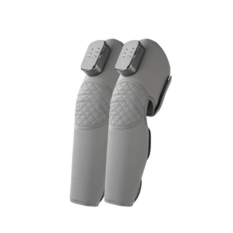 Pair of grey leg massager sleeves laid flat, showing zip closure and compression panels